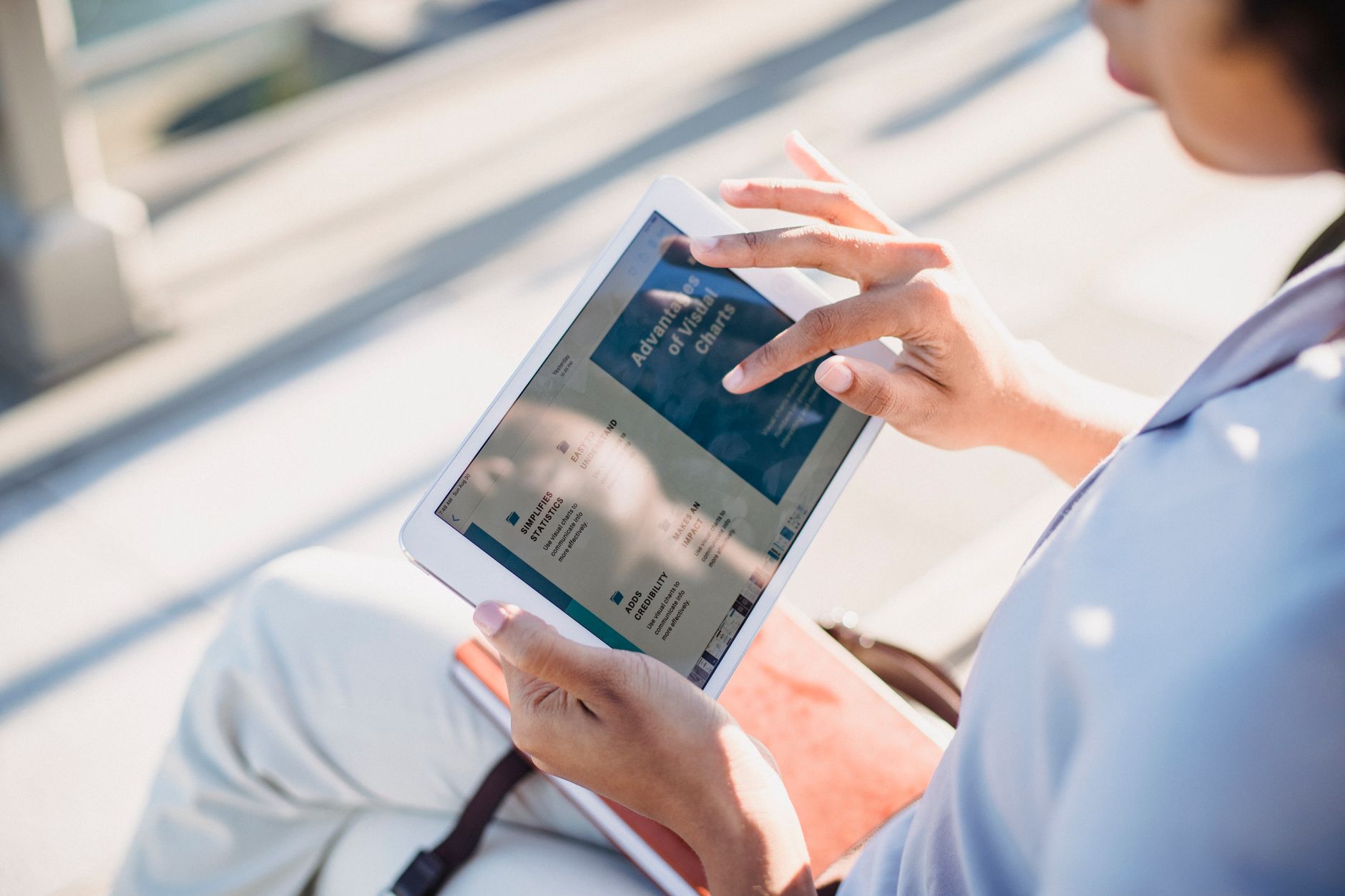 Person reviewing a long document on a tablet with Claude assistant open