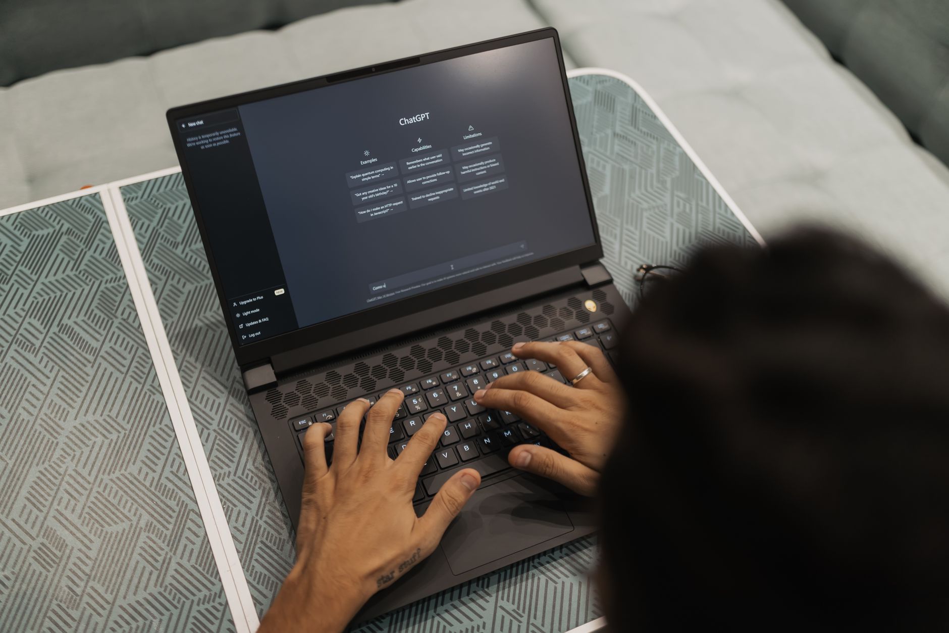 a person typing on a laptop with the ChatGPT signup page open on the screen
