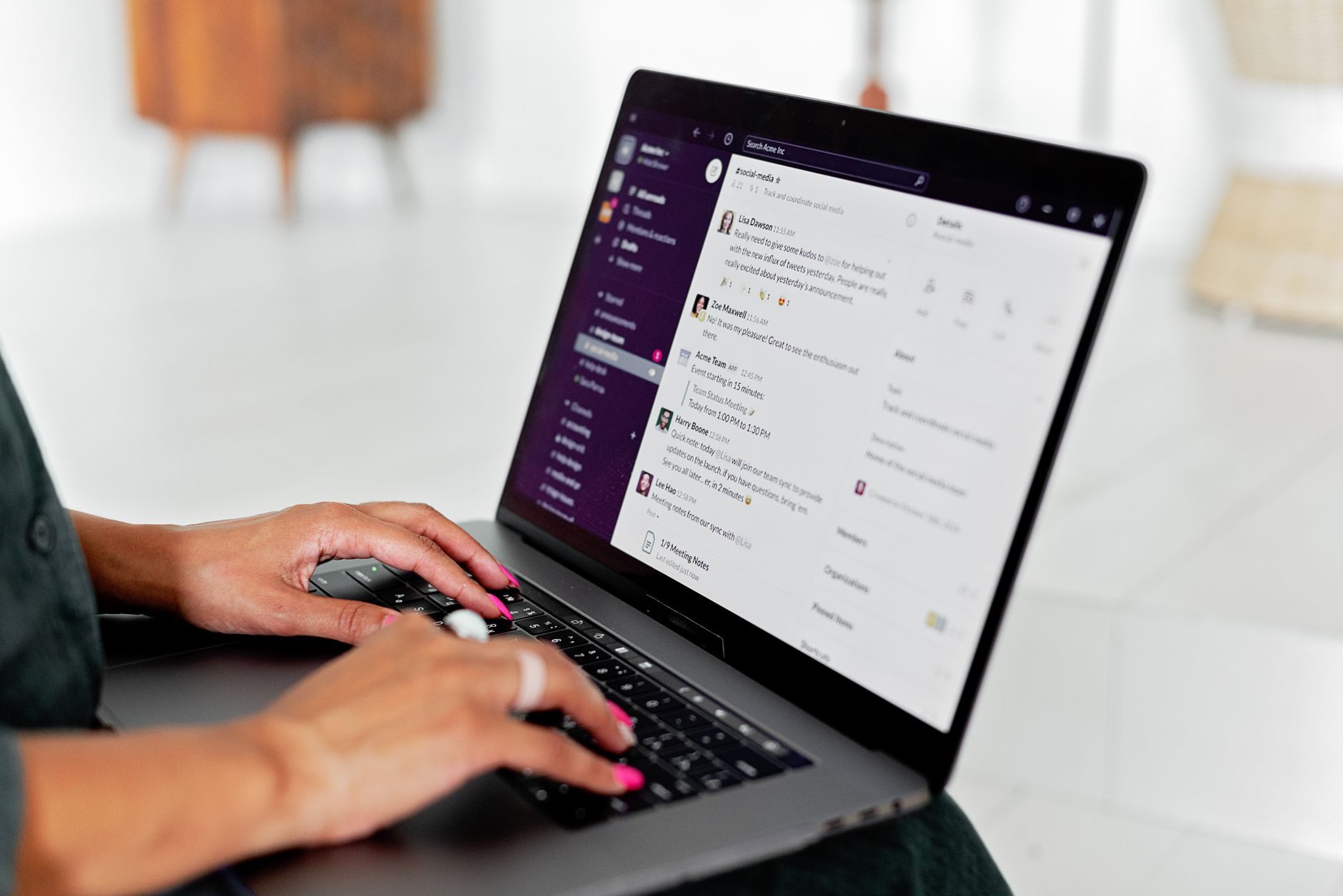 A person carefully reviews an email draft on a laptop screen, with a clear approve button and a check mark shown.
