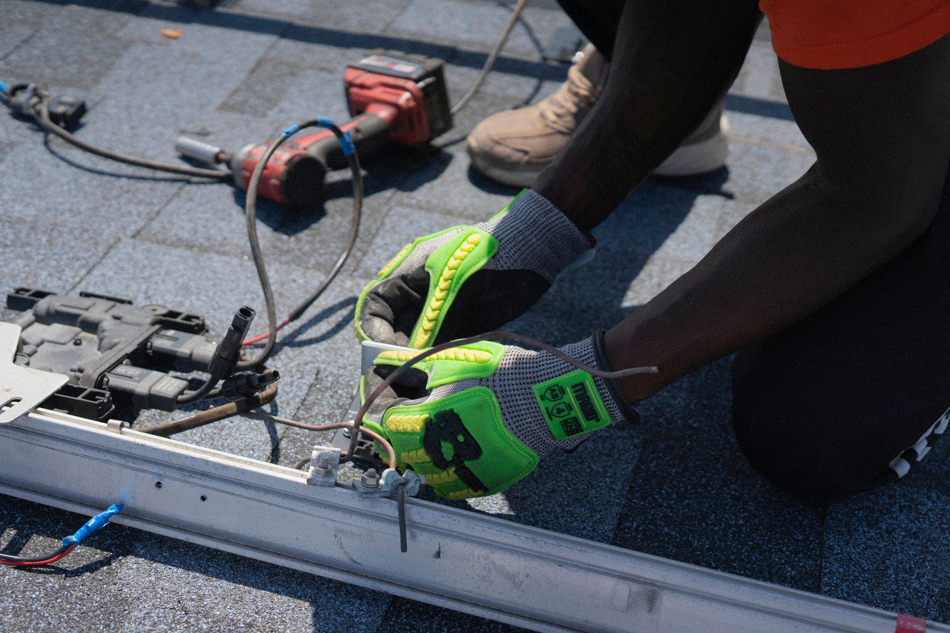 An electrician in work clothes carefully repairing electrical wiring inside a home
